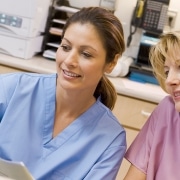 Smiling nurses looking at a computer