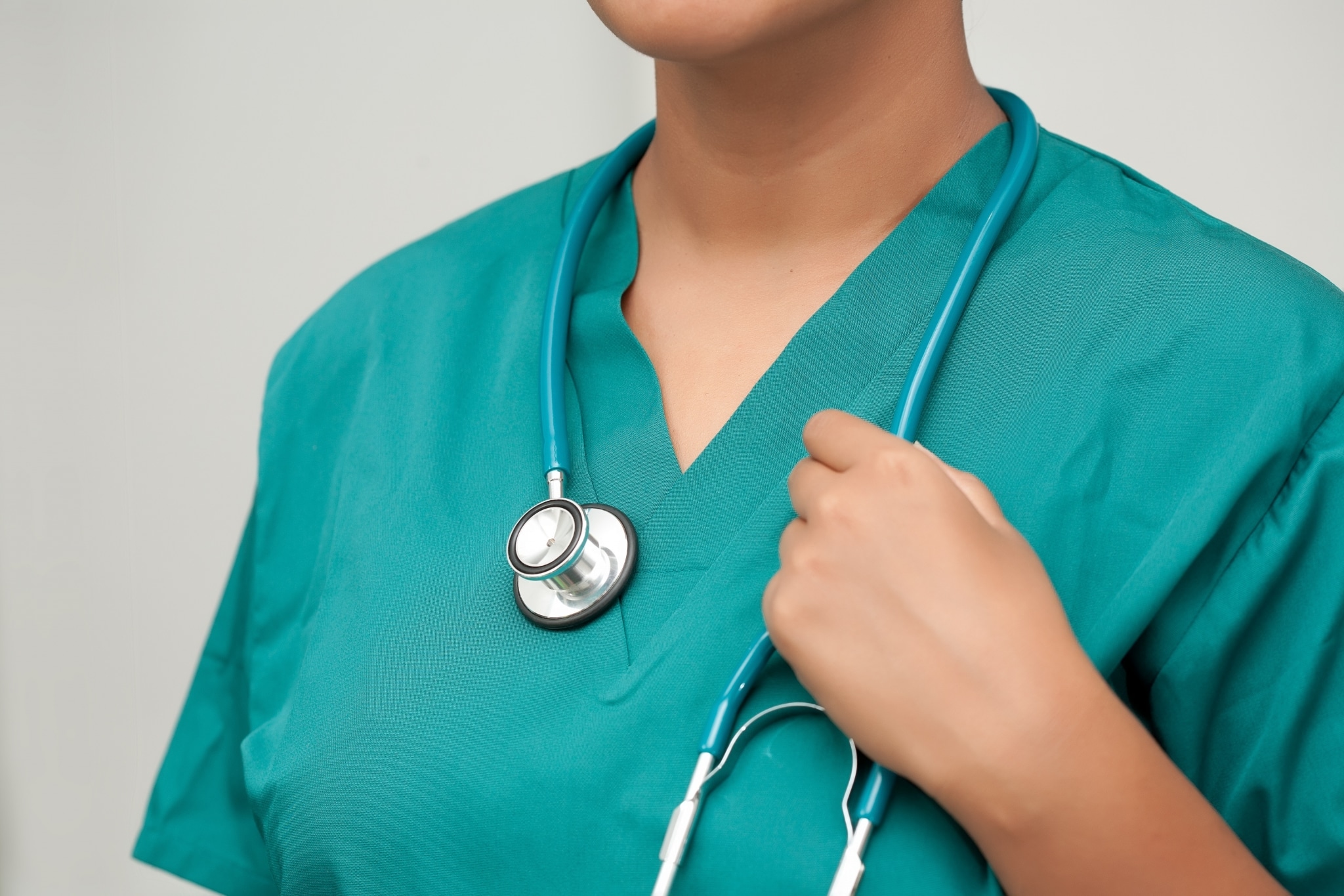 Close up of a woman in scrubs