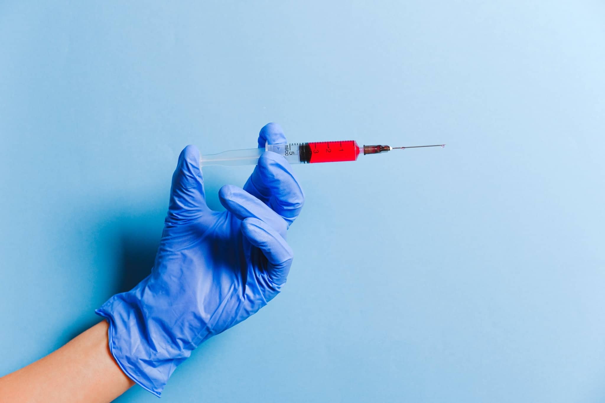Medical professional holding a syringe