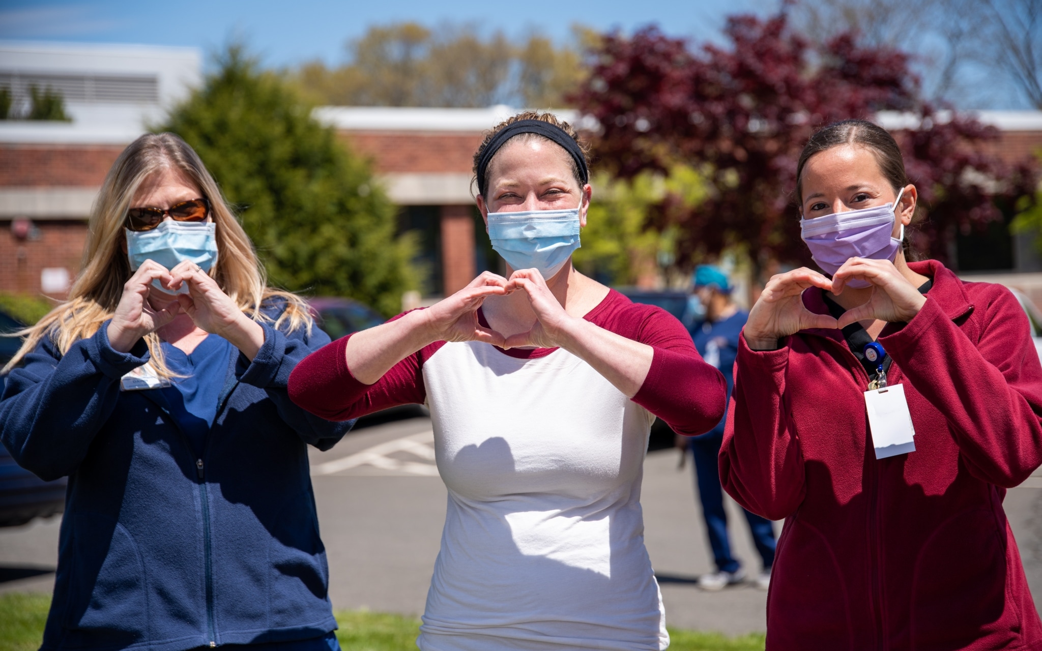Group of nurses making heart signs