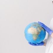 Nurse holding a globe