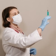 Medical professional holding a syringe