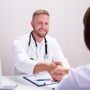 Health professional shaking a woman's hand