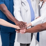 Medical professionals touching hands