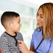 Female nurse listening to a child's heartbeat