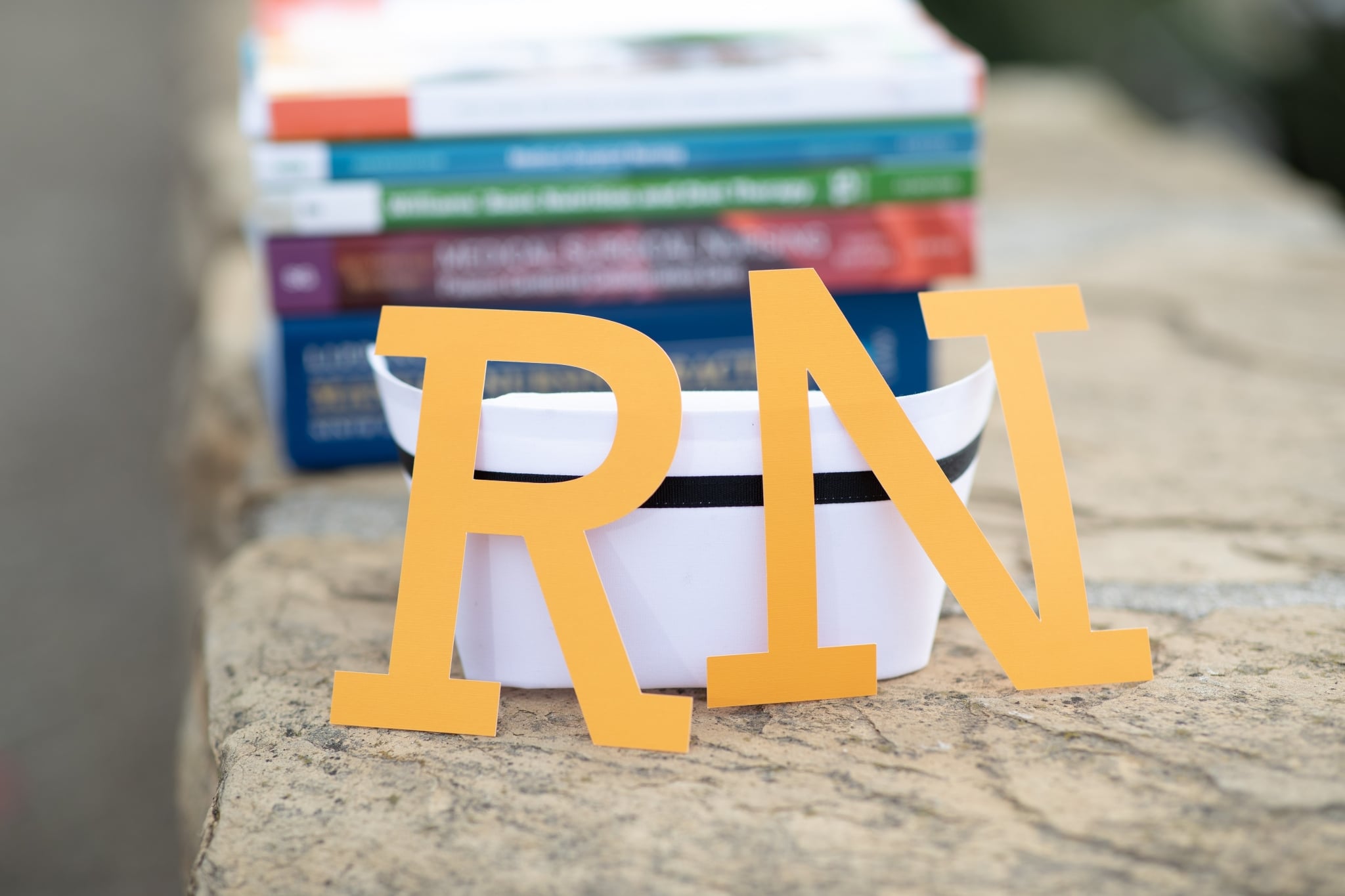 RN sign against a nurse hat