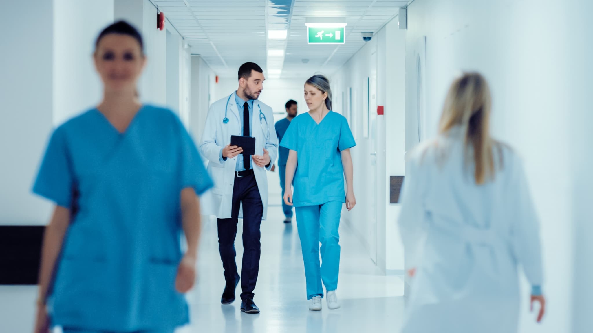 Healthcare professionals in a hospital hallway