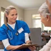 Senior nurse speaking with patients