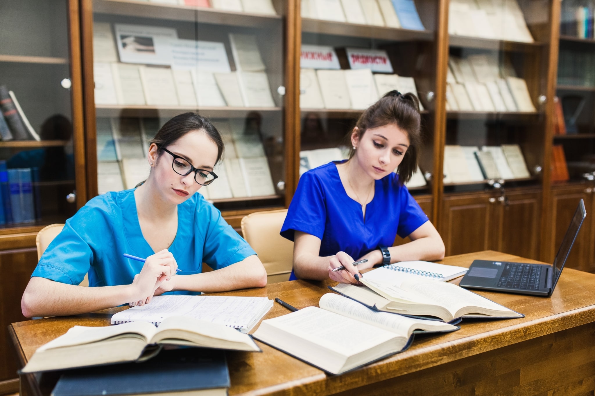 Medical students writing in notebooks