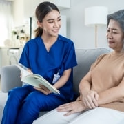 Asian nurse helping an elderly woman