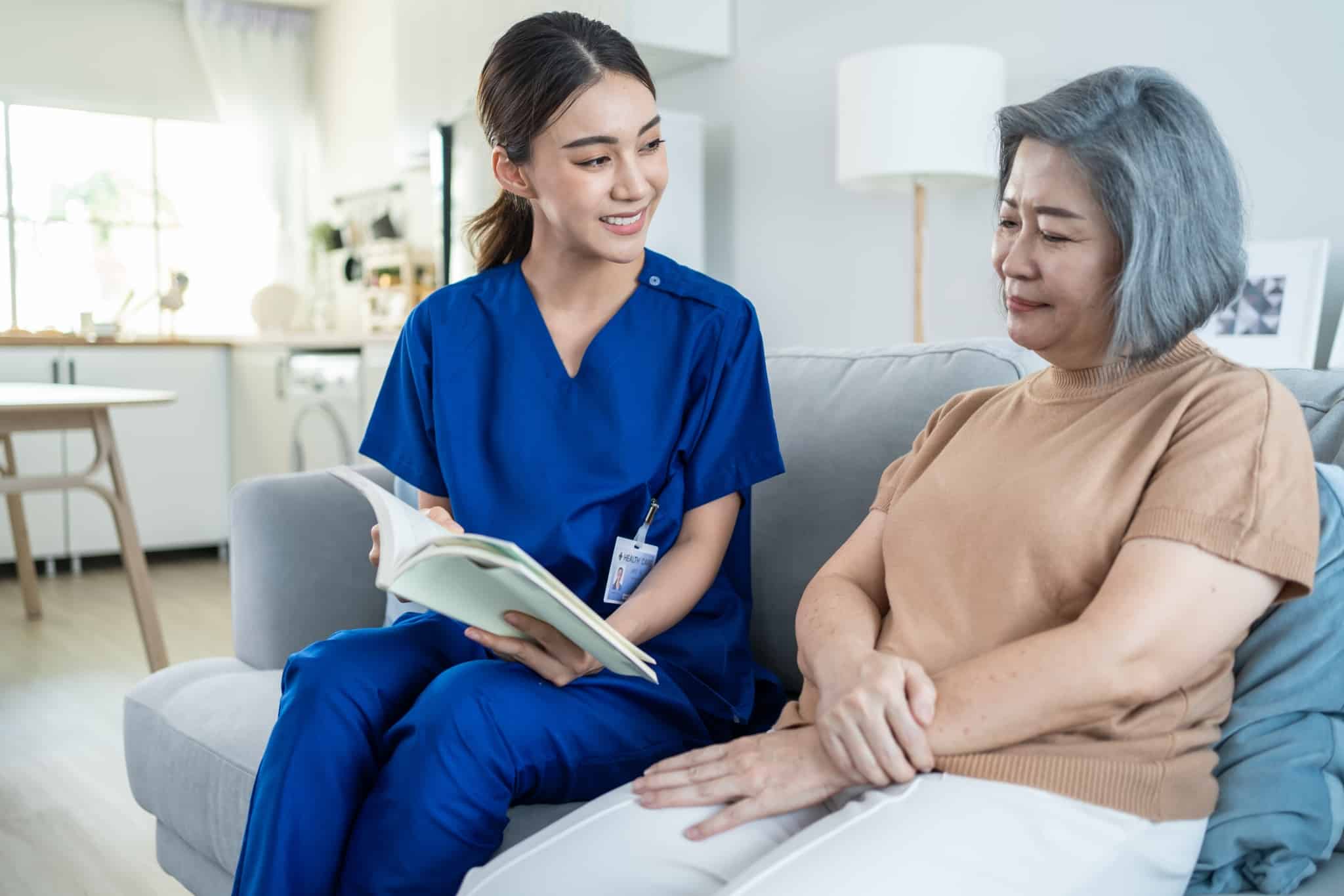 Asian nurse helping an elderly woman