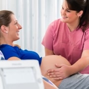 Midwife assisting a pregnant woman in the delivery room