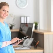 Young healthcare worker holding a tablet