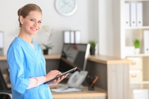 Young healthcare worker holding a tablet