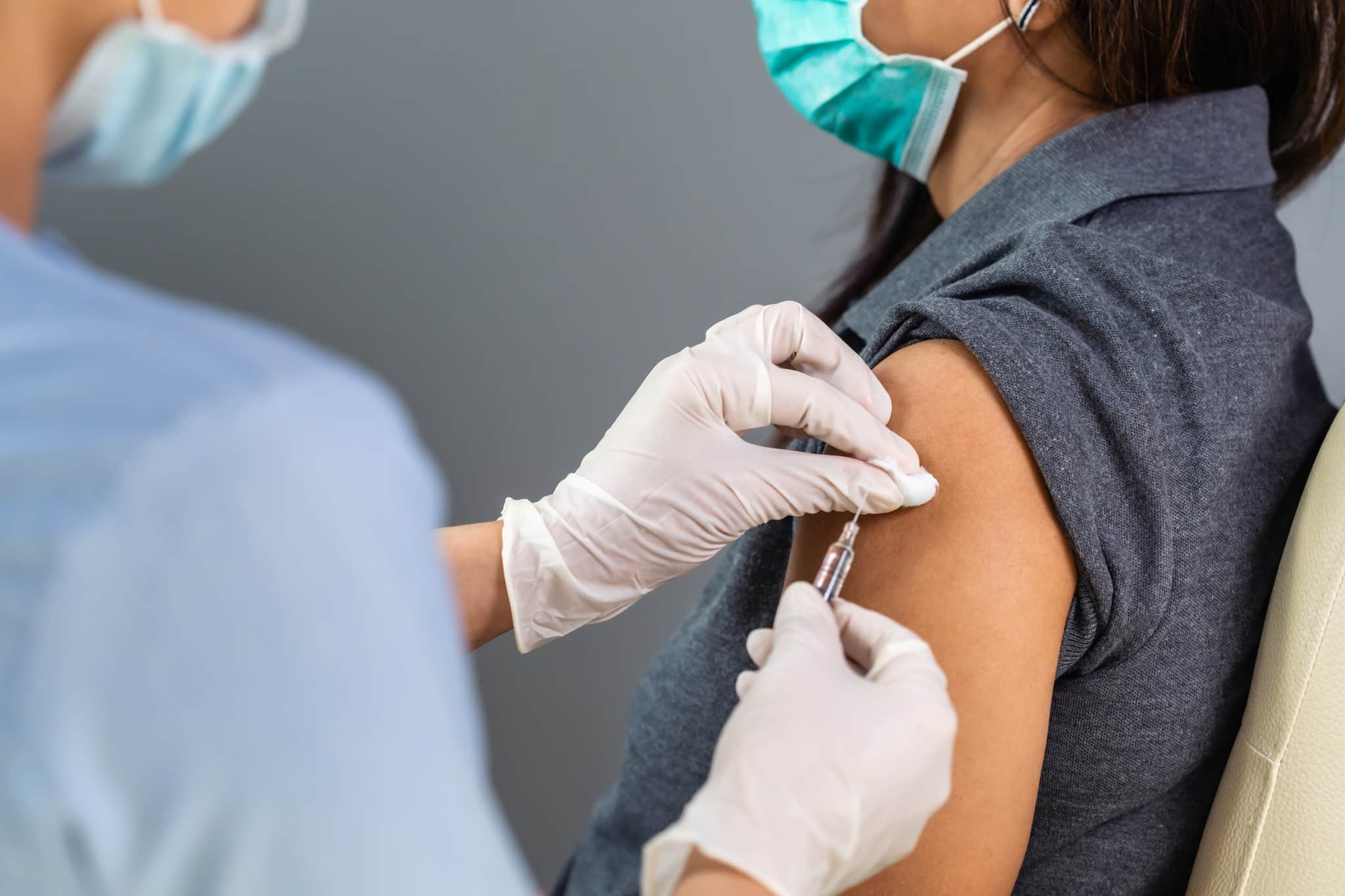 Healthcare professional holding a syringe