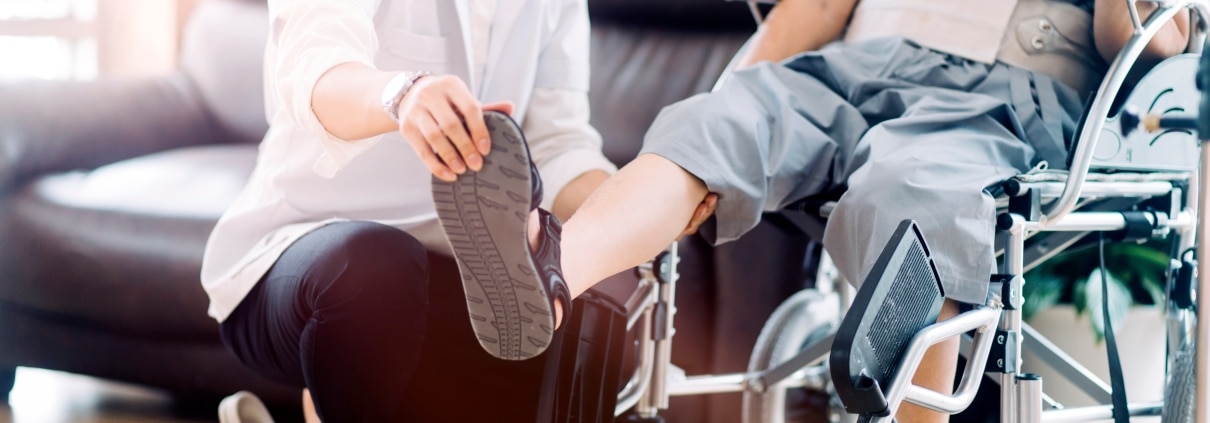 Physical Therapist Assistant manipulating a man's foot