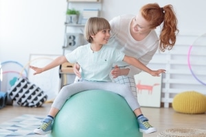 Physical Therapist Assistant with a child patient