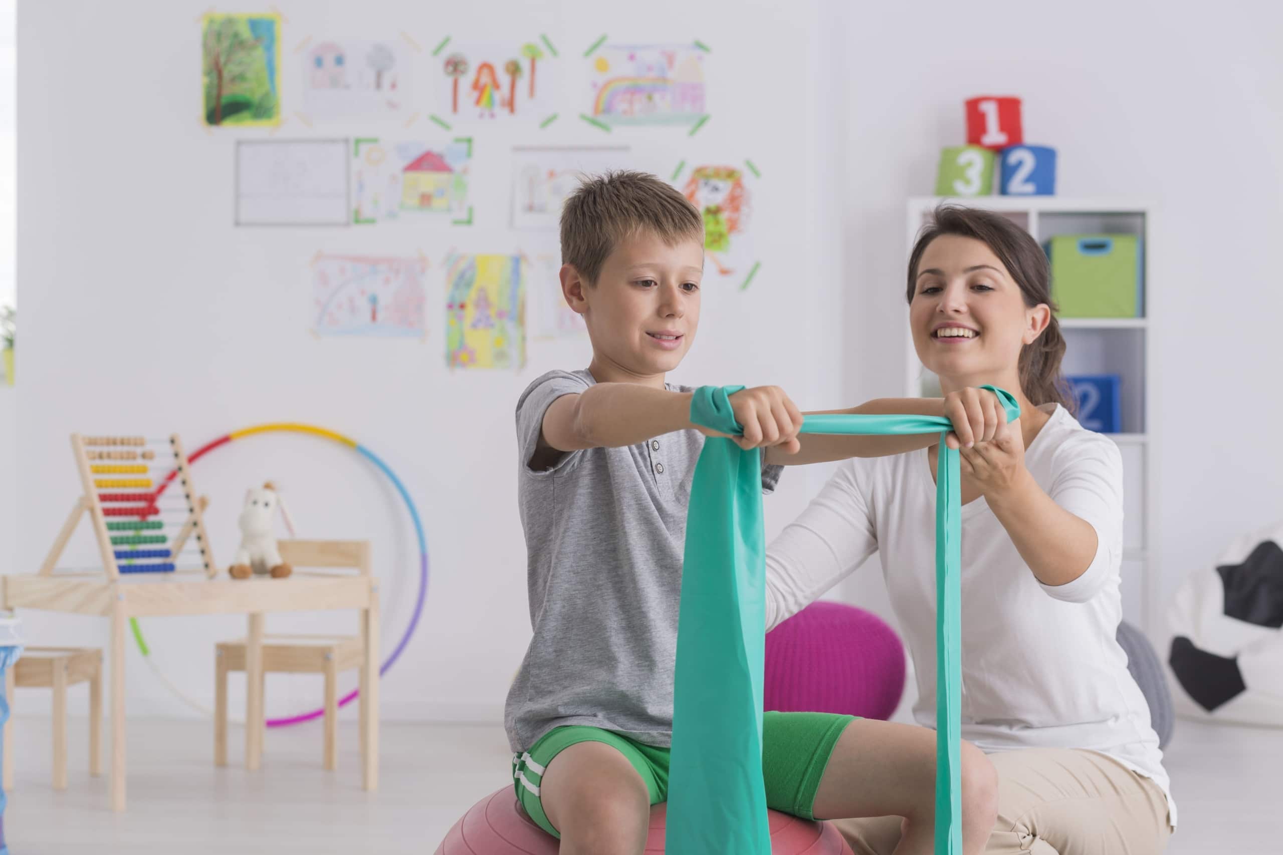 Physical Therapist assists a child patient