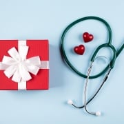 Stethoscope and present on blue background