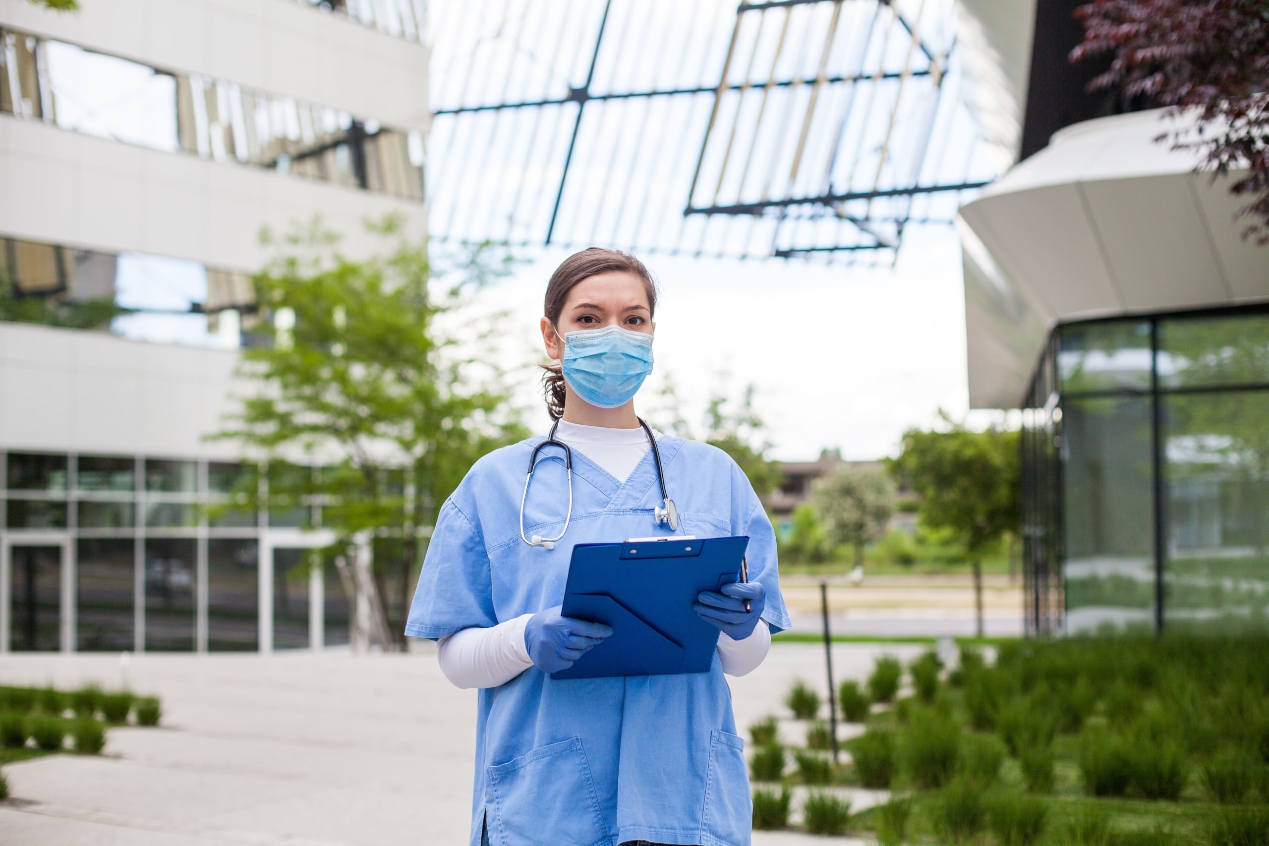 Medical professional in front of a hospital
