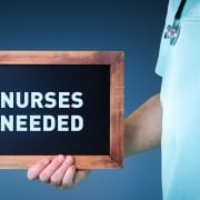 A sign that says nurses needed