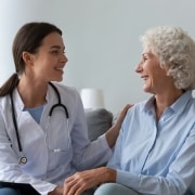 Happy young nurse with elderly patient