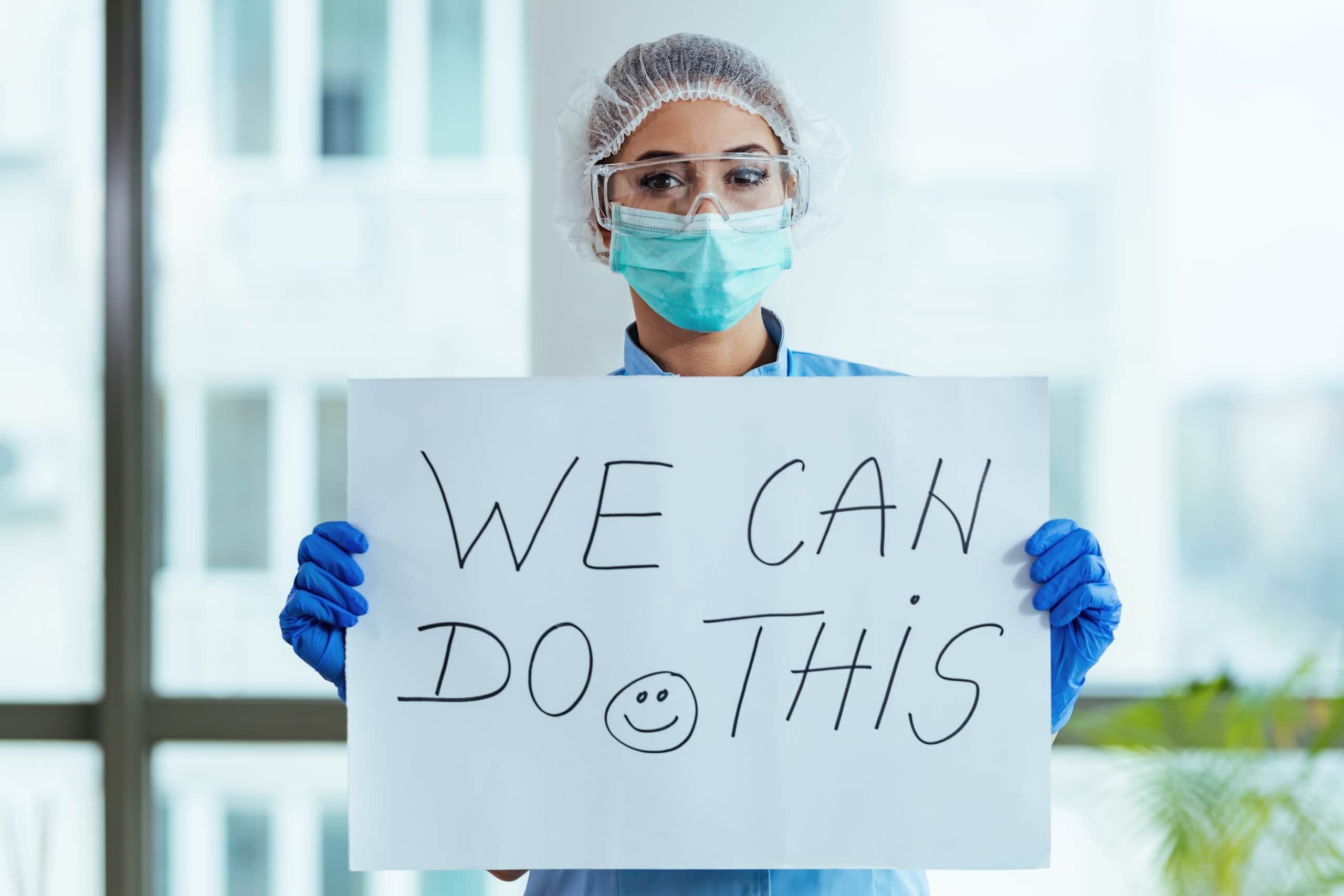 Nurse holding a motivational sign