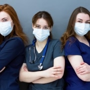 Trio of young masked nurses