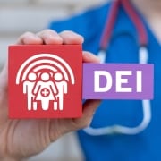 Nurse holding DEI blocks for diversity