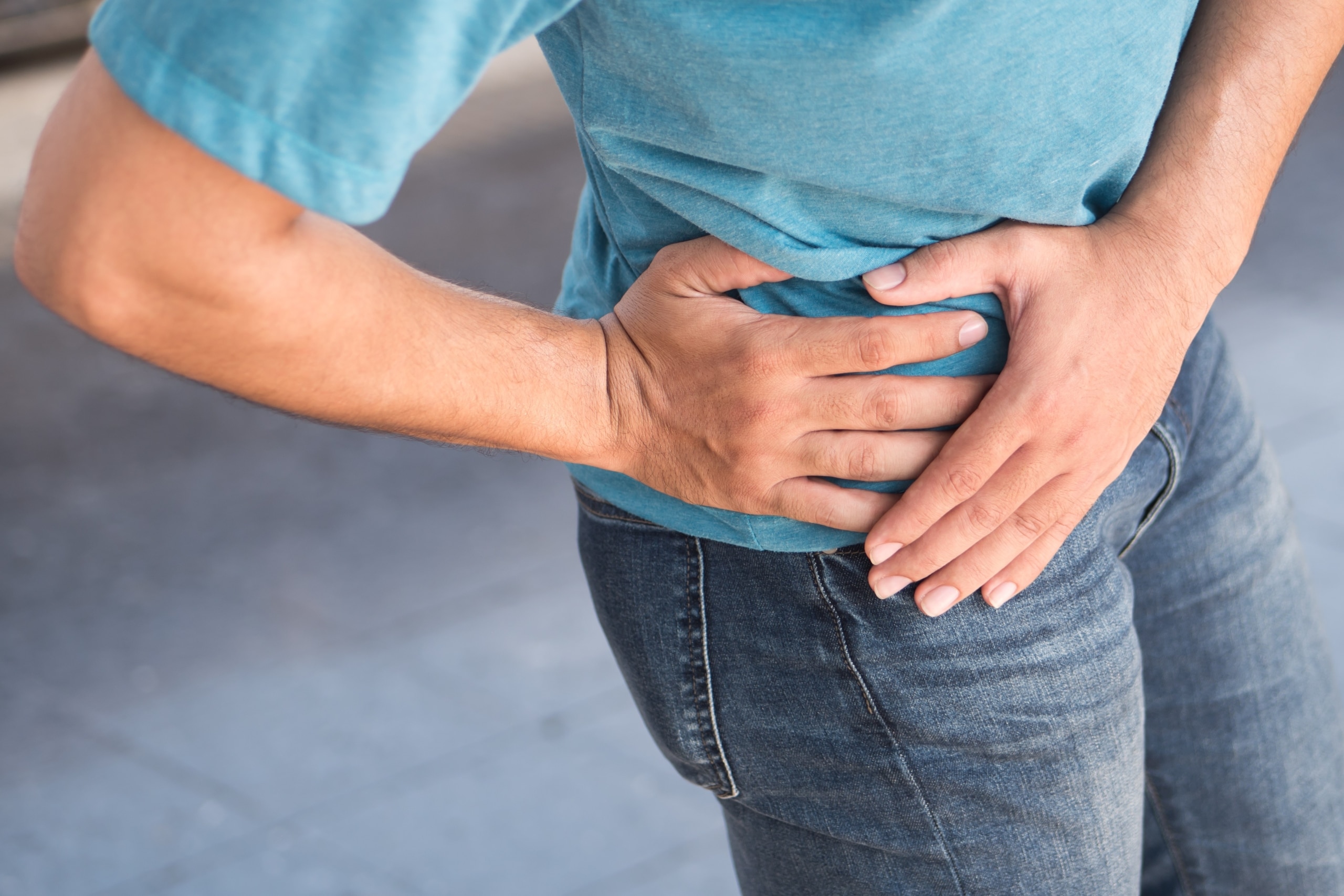 Injured man holding his hip