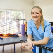 Smiling physical therapist assistant