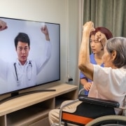 Elderly Asian woman in a telehealth physical therapy appointment