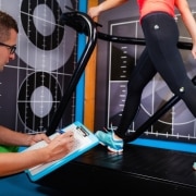 Male professional studying a patient's gait analysis in physical therapy