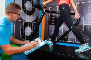 Male professional studying a patient's gait analysis in physical therapy