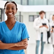 Beautiful African-American nurse in blue scrubs