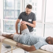 Physical therapy professional examining a patient