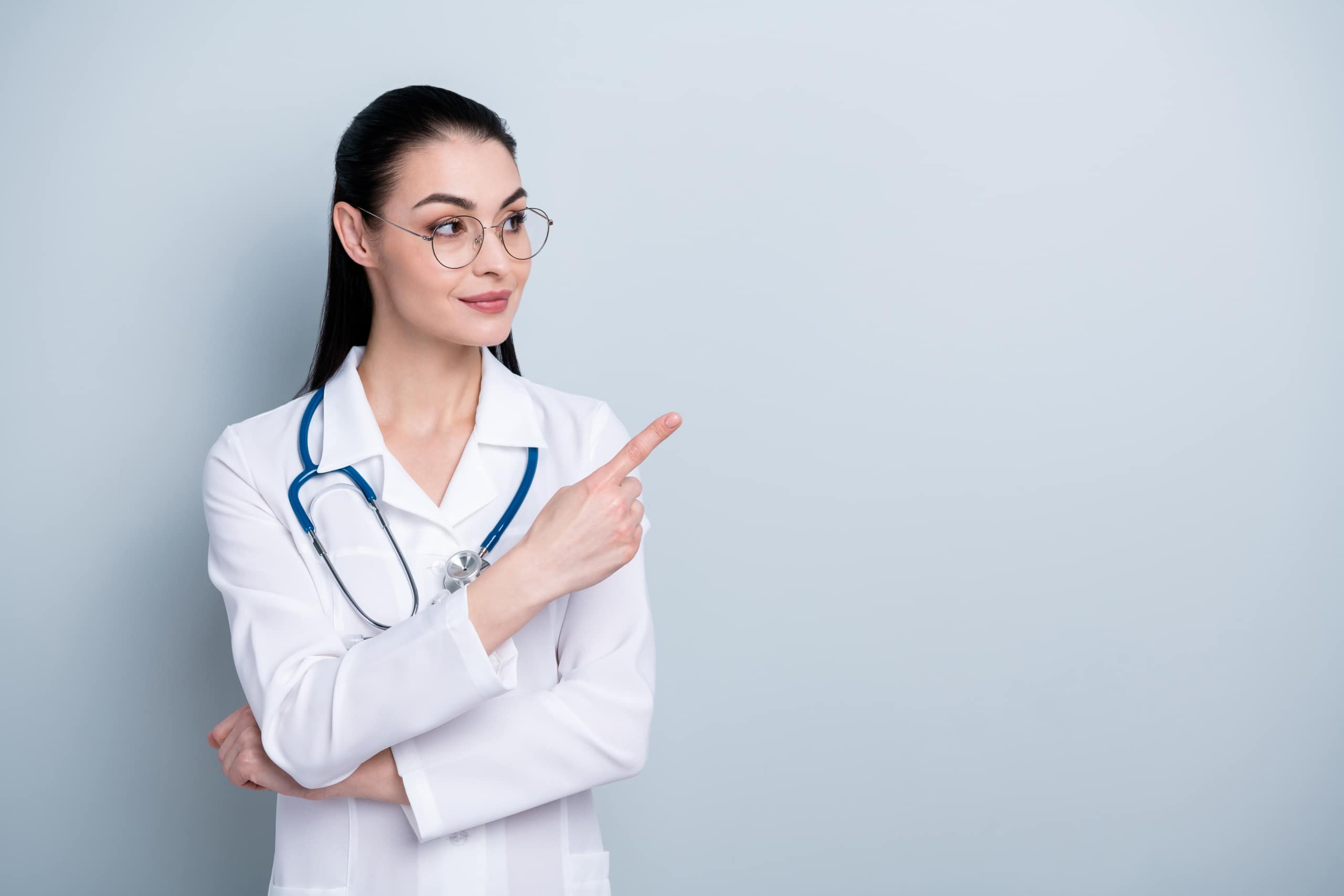 Beautiful medical professional pointing to the side