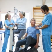 Older patients performing exercises at a physical therapy clinic