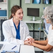 Beautiful medical professional speaking with an older patient