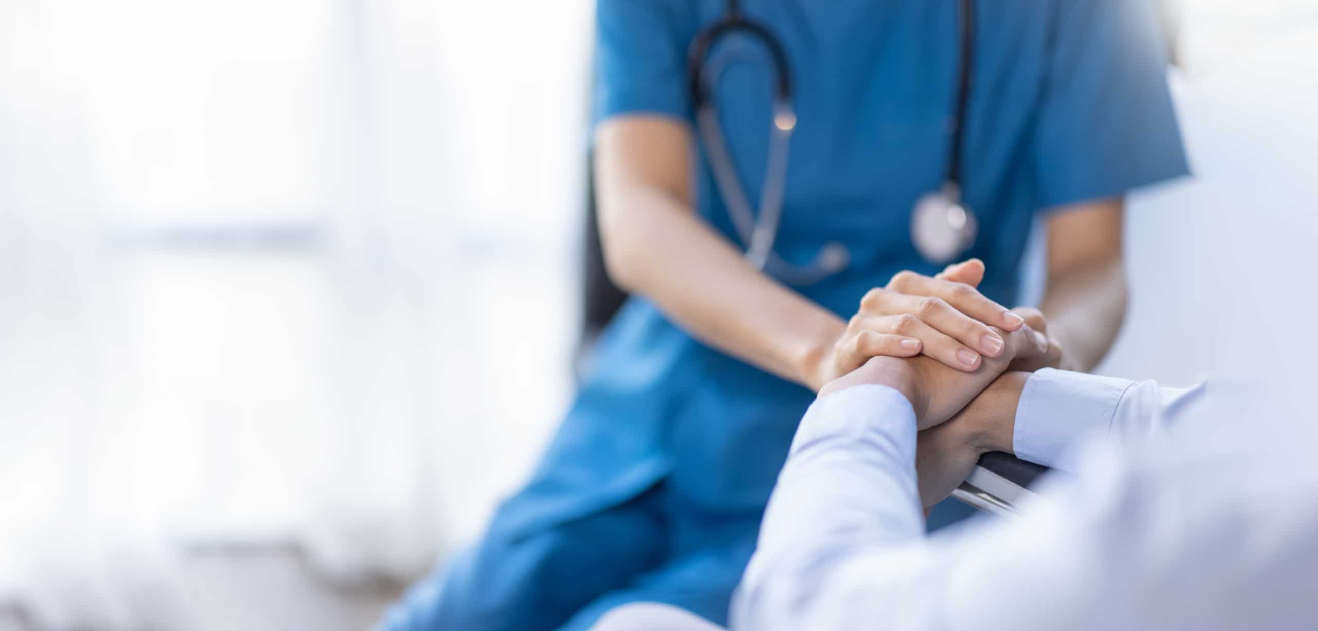 Close up of a nurse comforting a patient