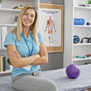 Blonde woman sitting in a physical therapy clinic